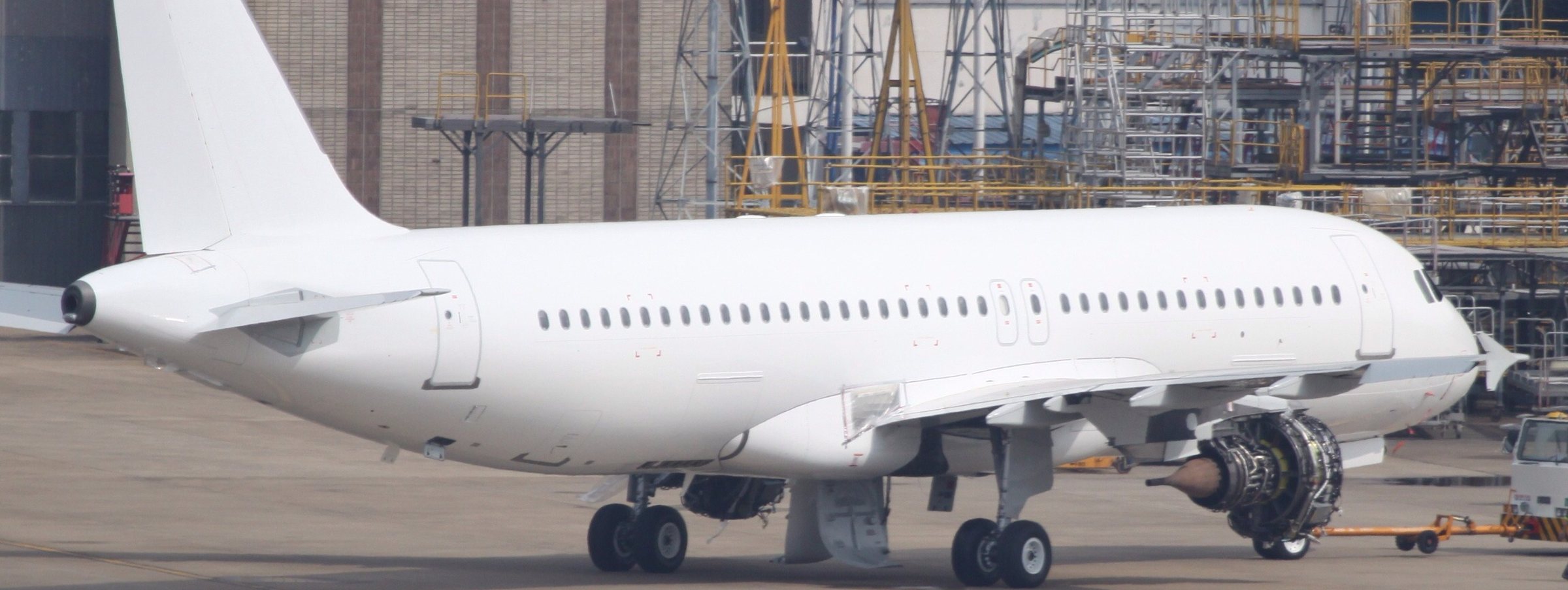 An unmarked white-tail narrowbody airliner