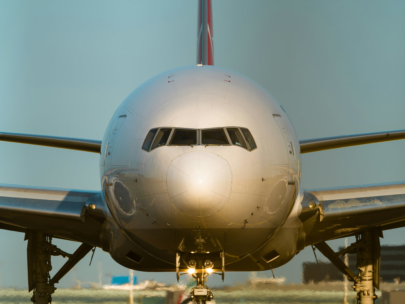 Commercial aircraft head-on on the tarmac — the hard asset behind Anisos Digital Units